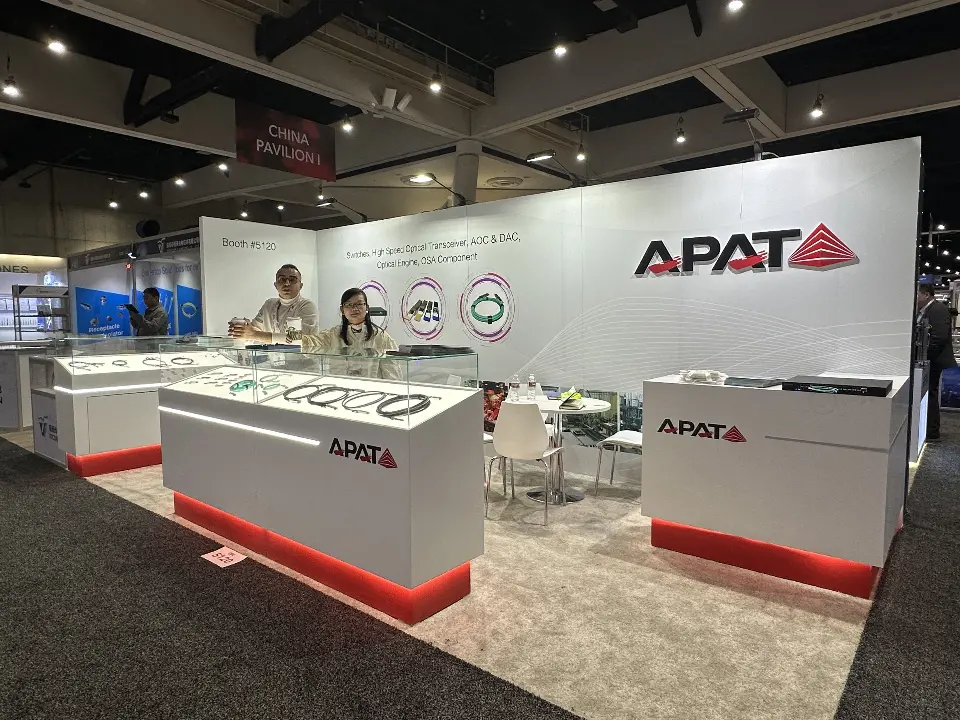 Wider angle of APAT counters, glass showcases and white wall with circular graphics