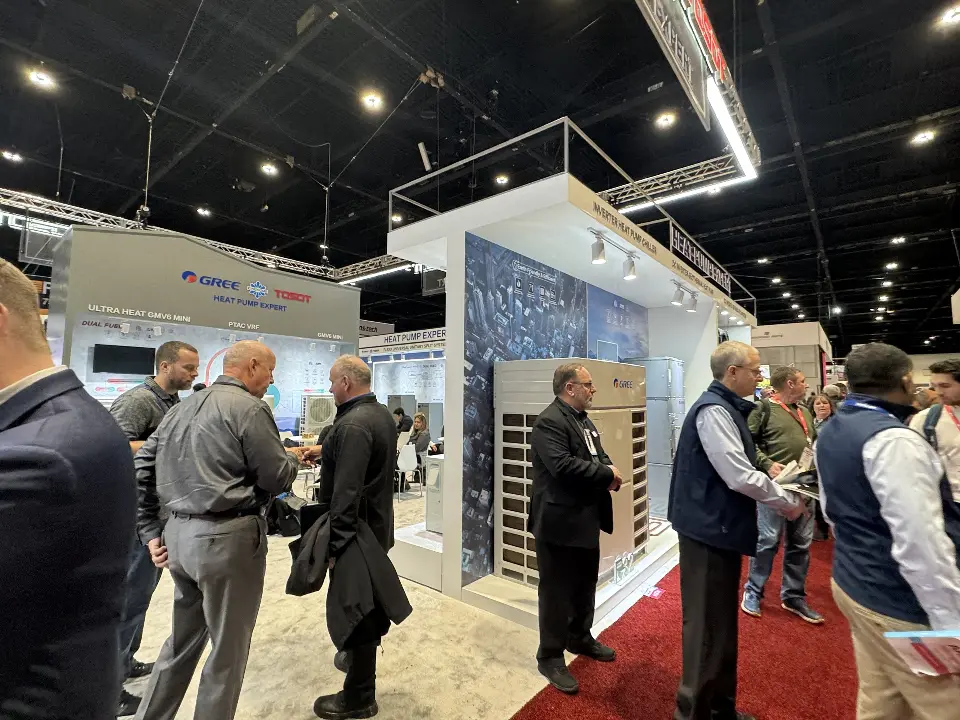 Visitors talking beside the packaged unit room and white display walls