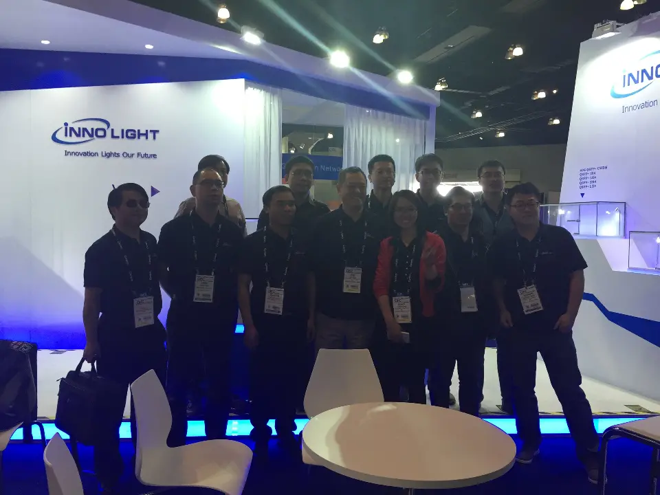 Team photo with the InnoLight logo wall and lit edges behind