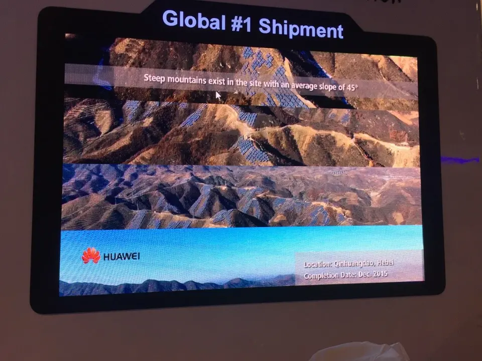 Close view of a framed video screen with mountain imagery and Huawei logo