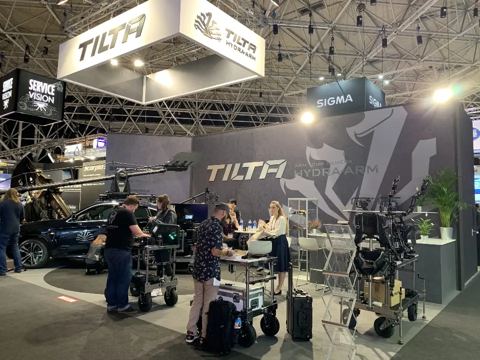 Tilta grey wall with large logo graphic, camera carts and a demo vehicle