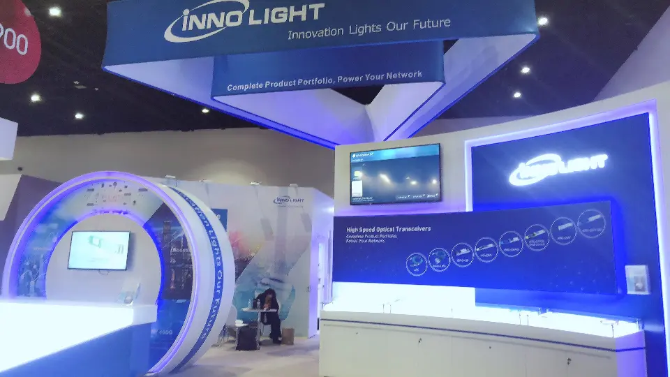 Front of the ring arch with its screen and a long white counter below the sign