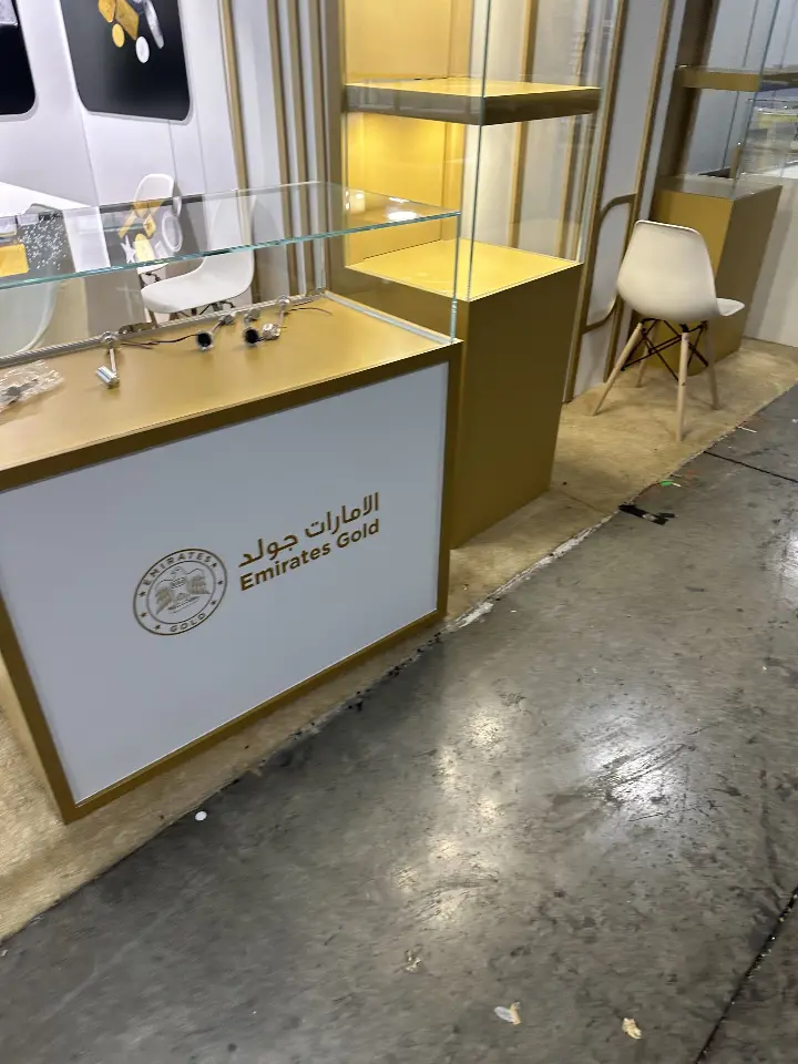 Small logo counter beside a gold-lined showcase in a portrait close view
