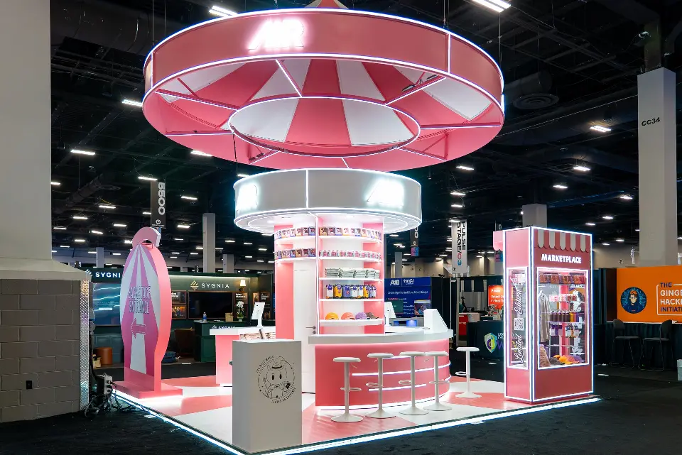 AIR booth at Black Hat USA 2026 with a pink and white striped ring canopy over a round merch counter