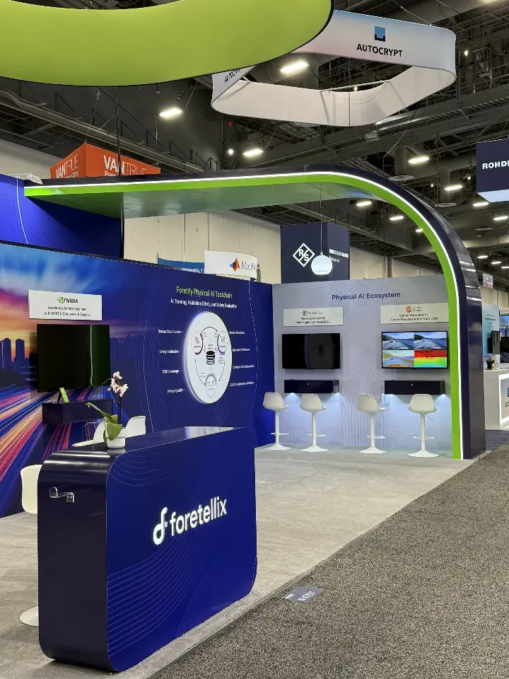 Demo station with wall screen and white stools beside a circular graphic
