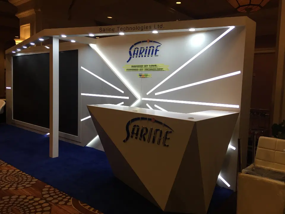 Close view of SARINE logo, light strip back wall and header with downlights