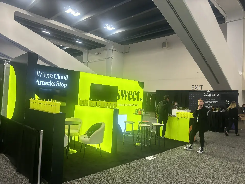 Wide view of the black booth with 'Where Cloud Attacks Stop' panel and seating