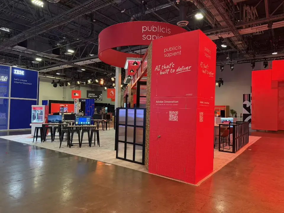 Red ring header with Publicis Sapient name above red walls and high tables