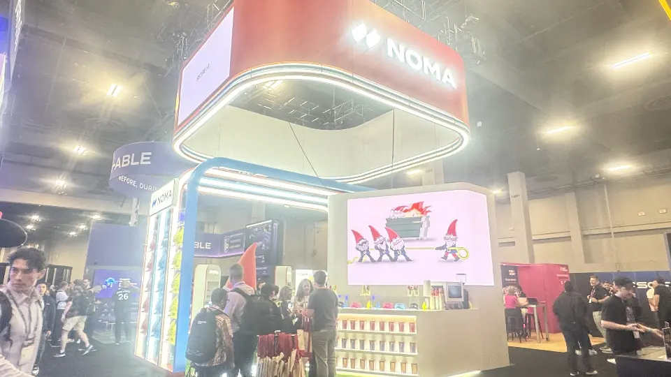 Wide view of the booth with gnome screen and merchandise counter