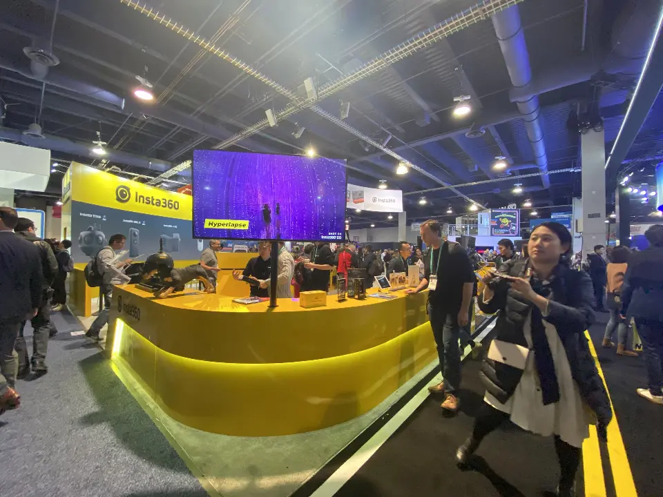 Busy curved Insta360 counter with lit base, product displays and Hyperlapse video screen