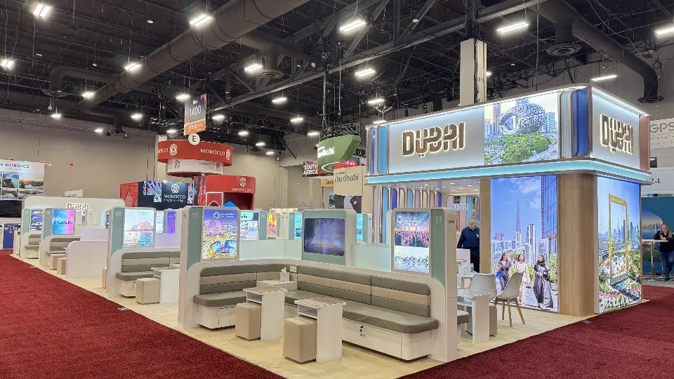 Corner view of the Dubai pavilion with lit header box and skyline graphics