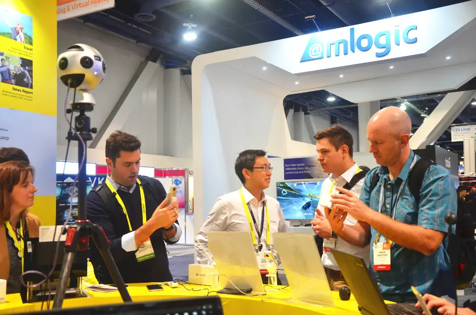 Staff demonstrating cameras to visitors beside a 360 camera rig