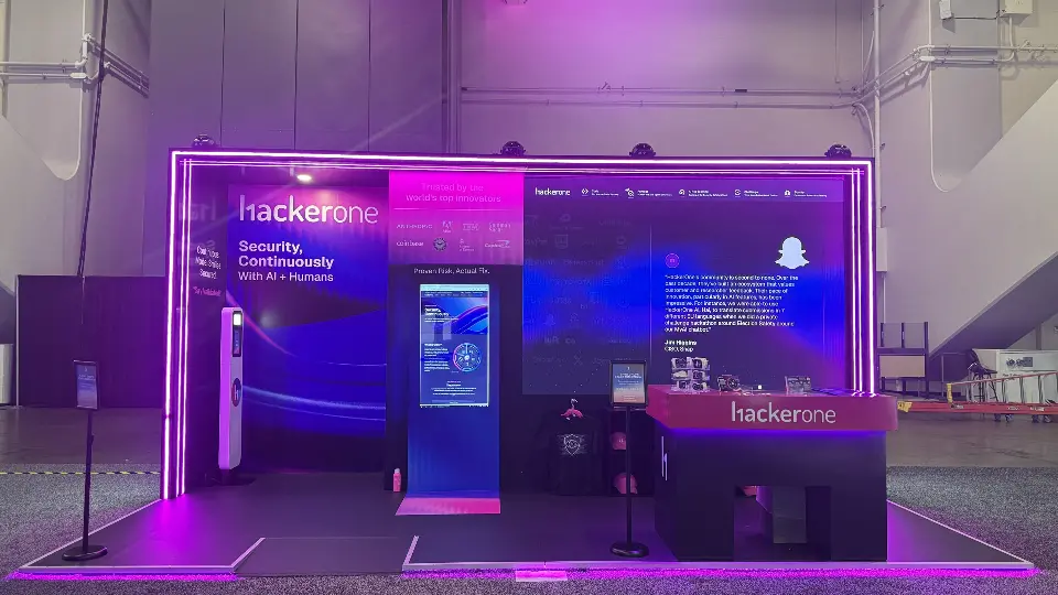 Wide front view with kiosk screen and wall graphics in purple light