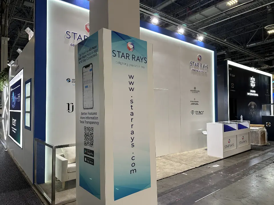 Corner pillar wrap with web address before the lit-edge Star Rays wall