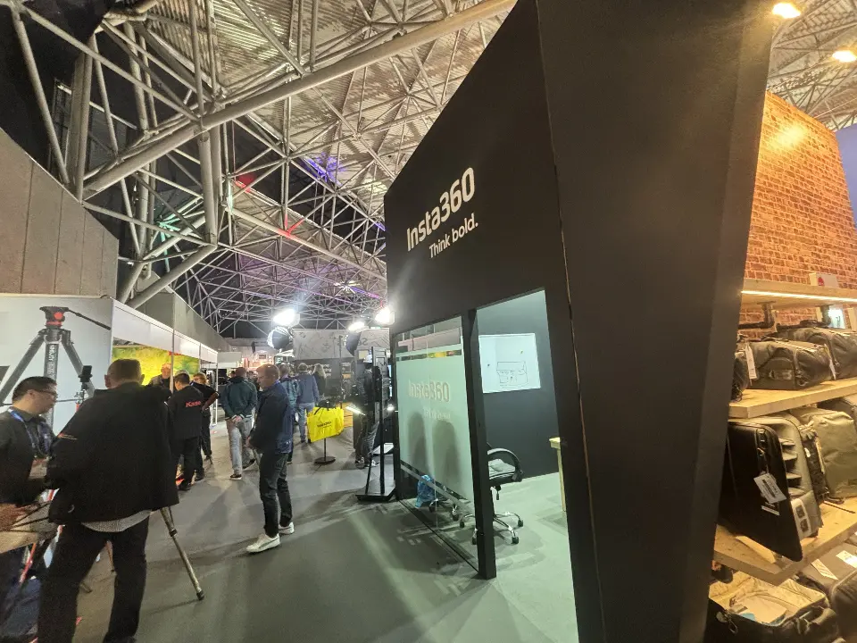 Tall black corner wall with white Insta360 lettering beside a demo area