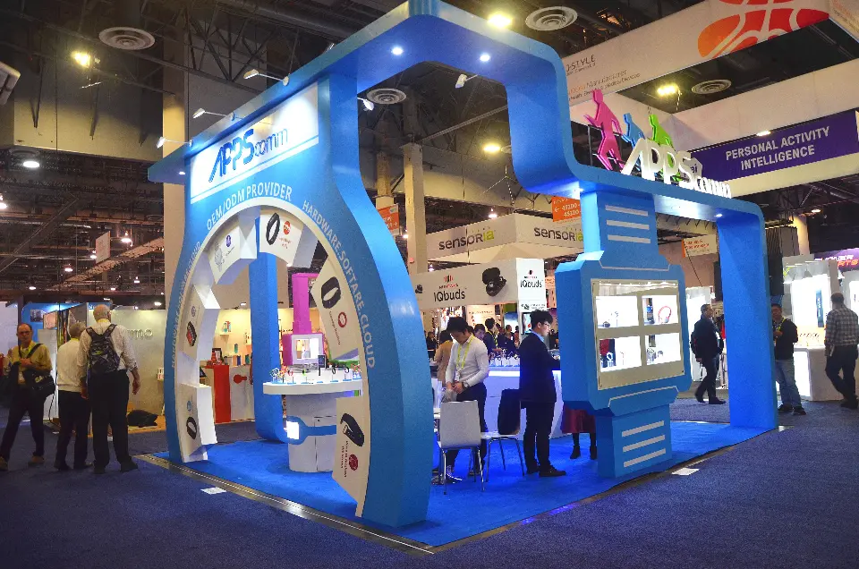 Corner view of the blue and white APPScomm structure with a watch-shaped display case