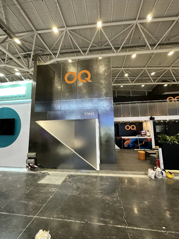Portrait view of the black tower with OQ logos and an angled white base