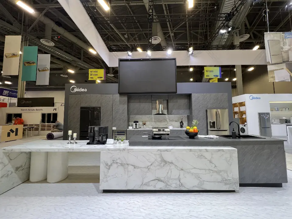 Marble-look island with a cooktop below a range hood