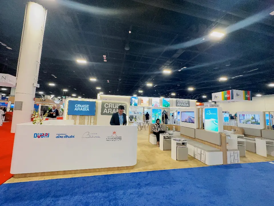 Long front counter with Dubai and Abu Dhabi logos and backlit panels