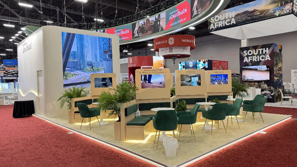 Corner of the pavilion with green chairs, palms and wood-look tables
