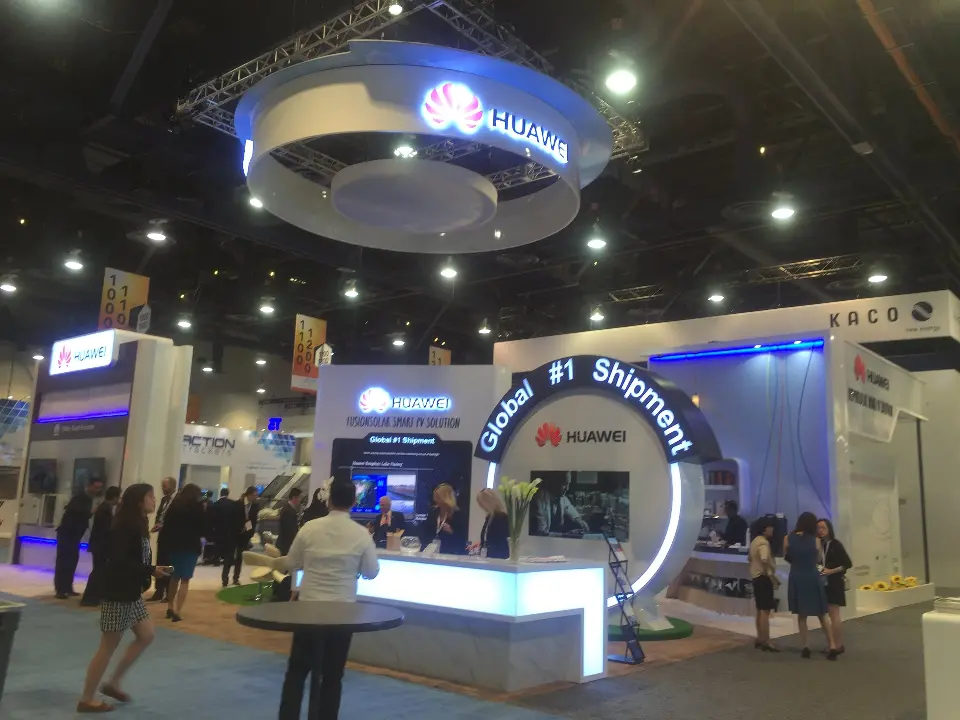 Visitors gathered by the lit counter with the arch and ring behind them