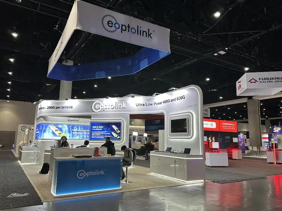 Wide view of wall screens, lit counter and eoptolink header above the booth