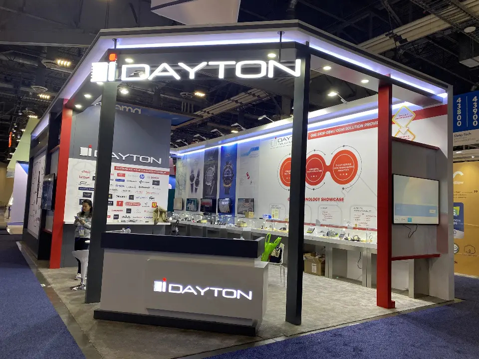 Front corner with lit DAYTON header, logo counter and red circle graphics on the back wall