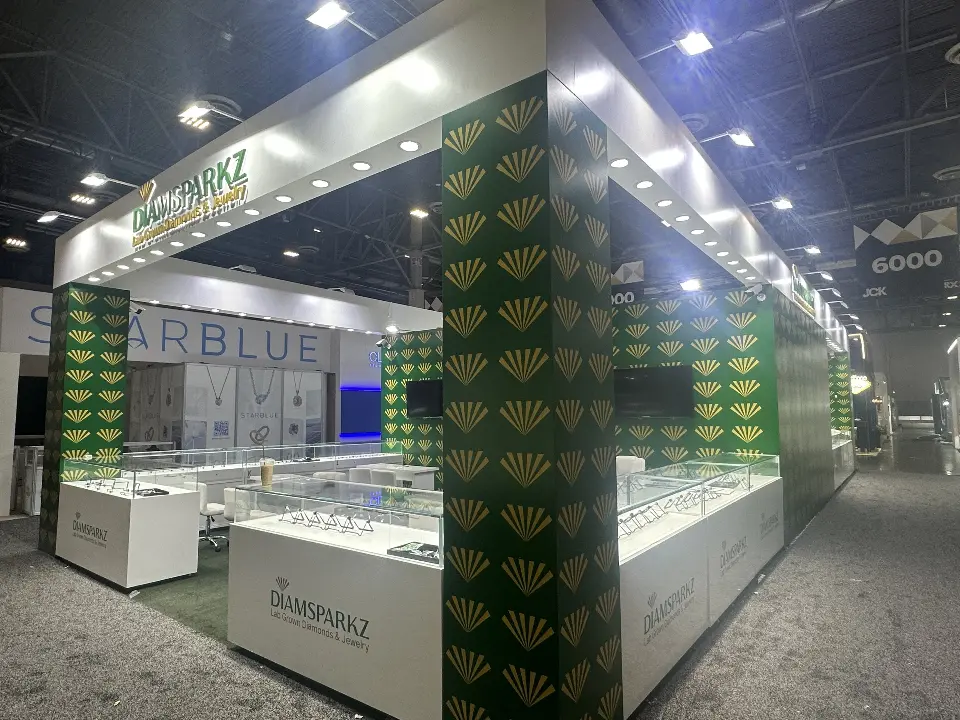 Corner view of glass showcases between green fan-pattern columns