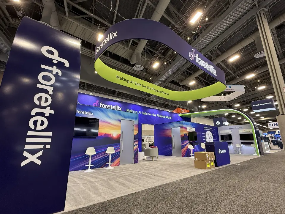 Logo column and lime-green ring framing the booth interior in a wide view