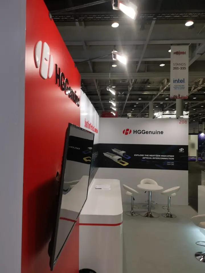 Side view along the red HGGenuine wall toward the meeting corner and next-gen interconnection graphic