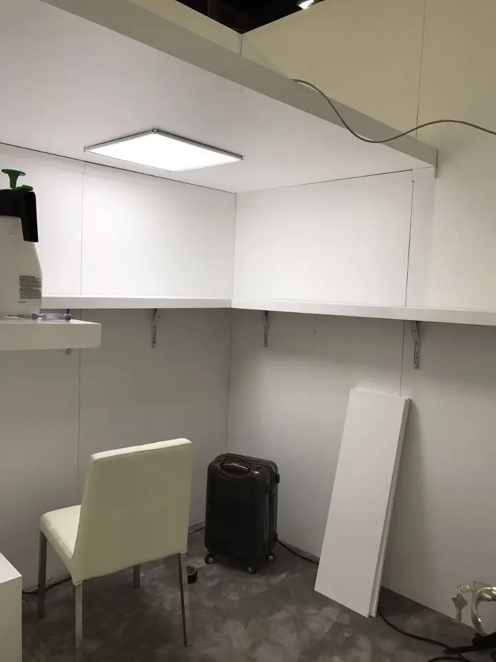 Plain white back room with a chair and a cabinet