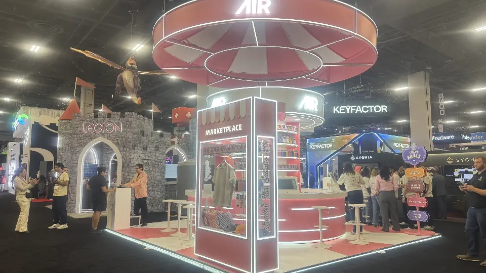 Marketplace kiosk with merch shelves, lit edges and the AIR ring sign above