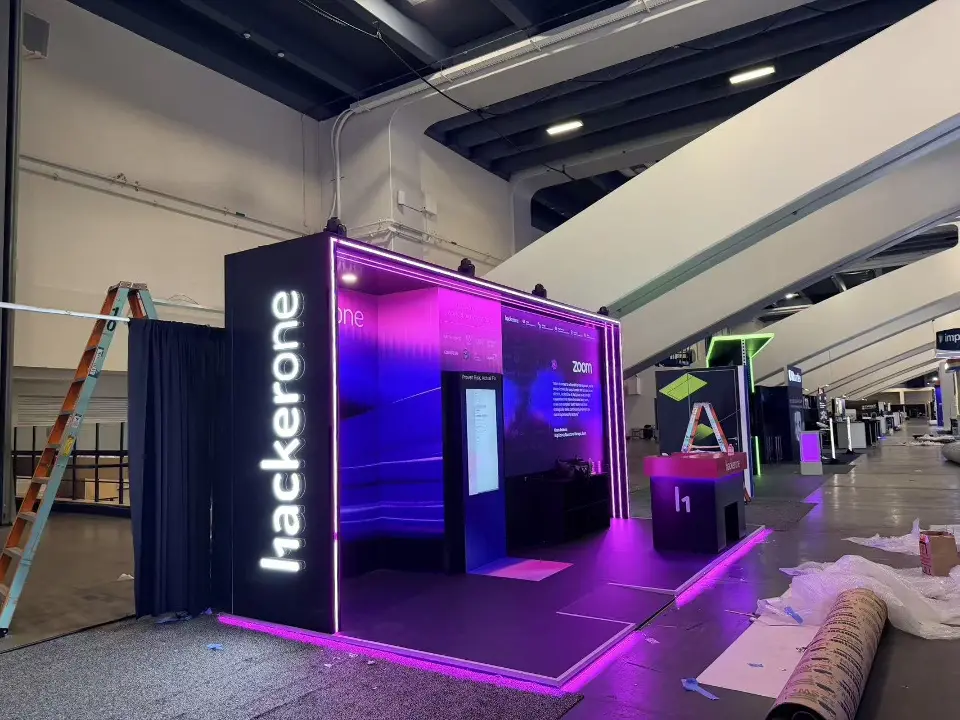 Side wall with vertical hackerone lettering beside a ladder and crates