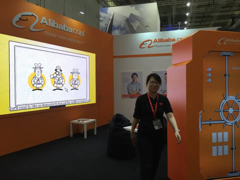 Yellow cartoon graphic wall and orange vault-style door beside a staff member