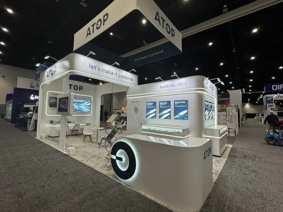 Side view of lit display cases, a round graphic disc and ATOP header