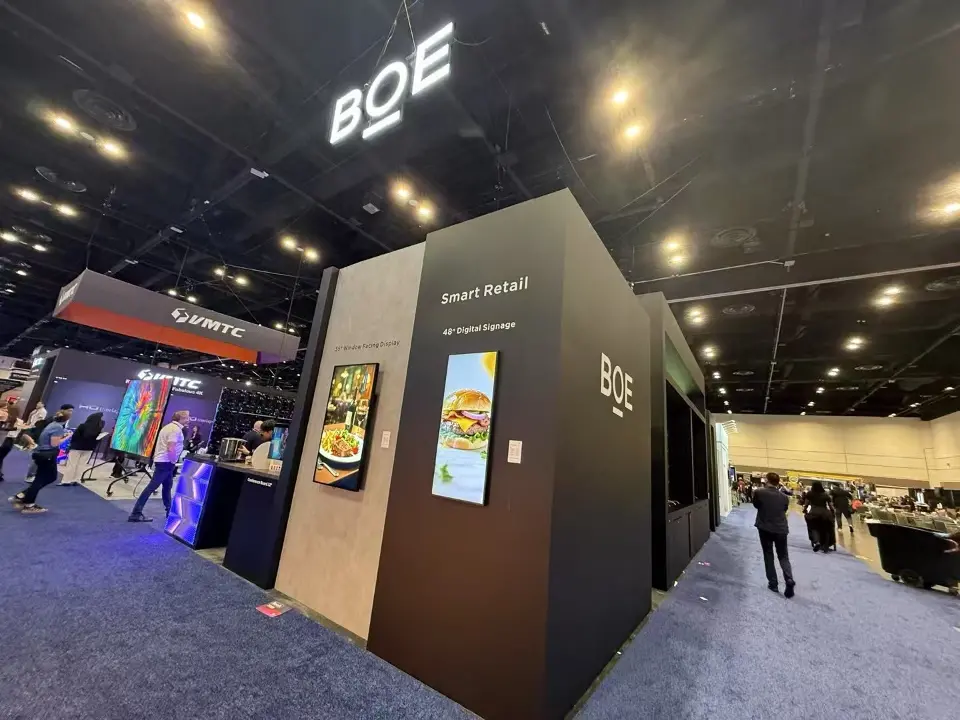 Corner of the BOE booth with Smart Retail digital signage screens set into a dark wall