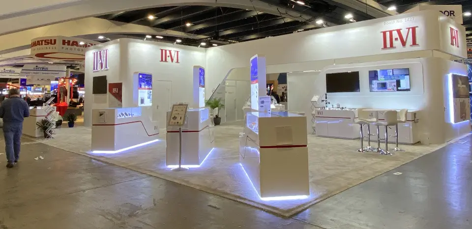 Wide angle of the booth corner with a white pedestal and lit floor edge