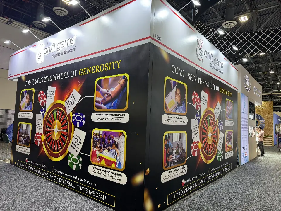 Long black wall with roulette wheel and Come Spin the Wheel of Generosity text