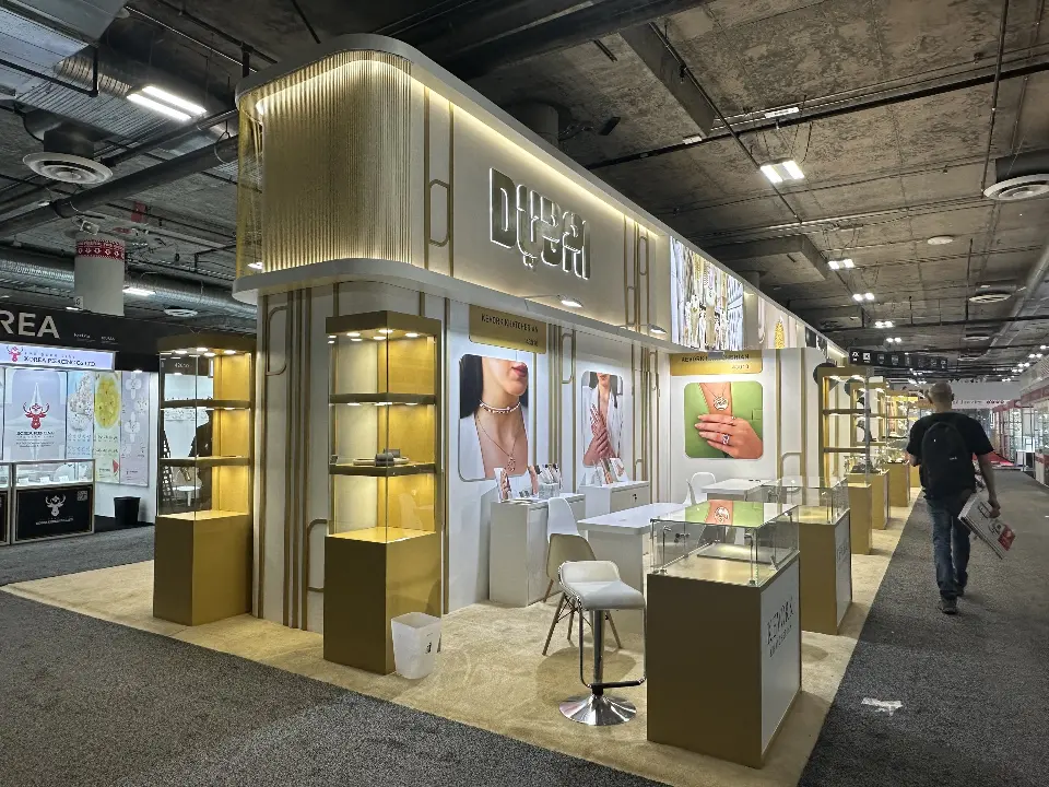 Corner view of lit showcases with a visitor walking past