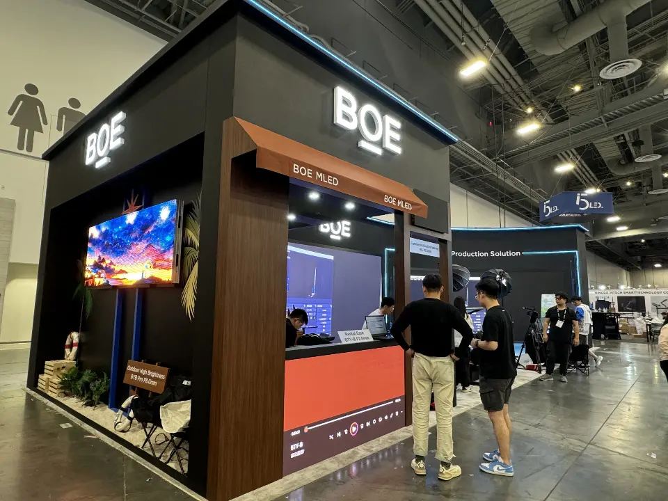 BOE corner with wood-look canopy, lit logo, video screen and orange counter