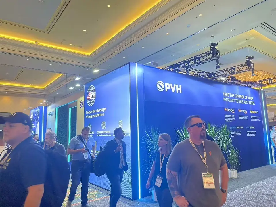 Blue PVH enclosure with Made in USA badge, product messaging and edge lighting beside the aisle