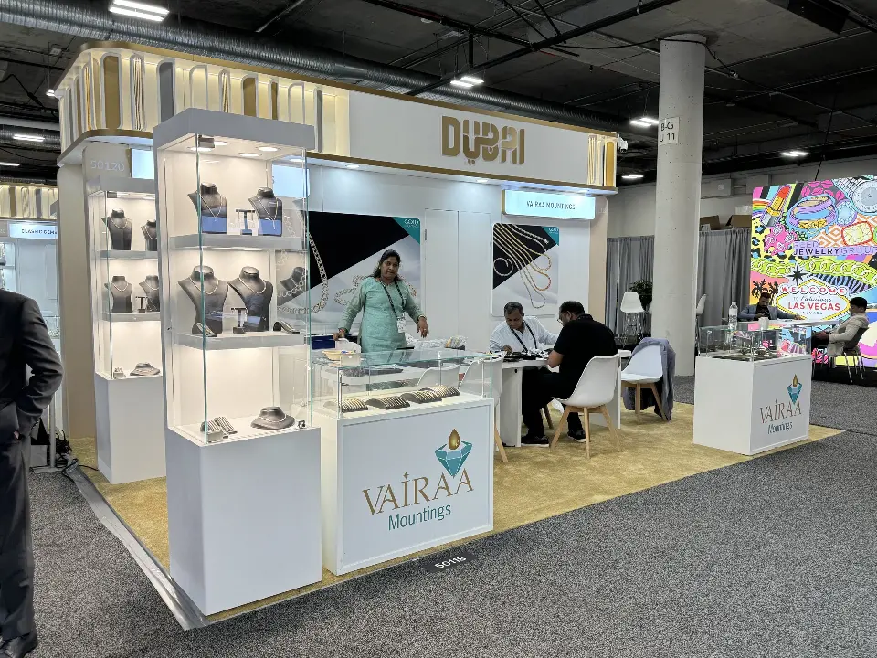 VAIRAA stand with necklace busts in tall lit showcases and branded counter