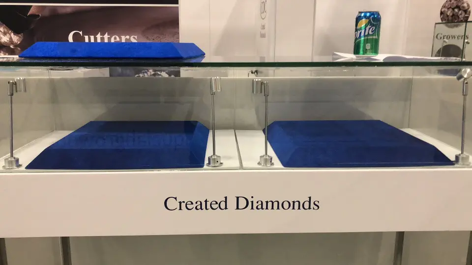 Glass showcase with blue tray set against the dark Cutters wall graphic