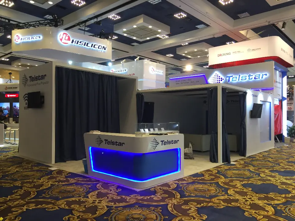 Front of the booth on patterned ballroom carpet with hanging signs above