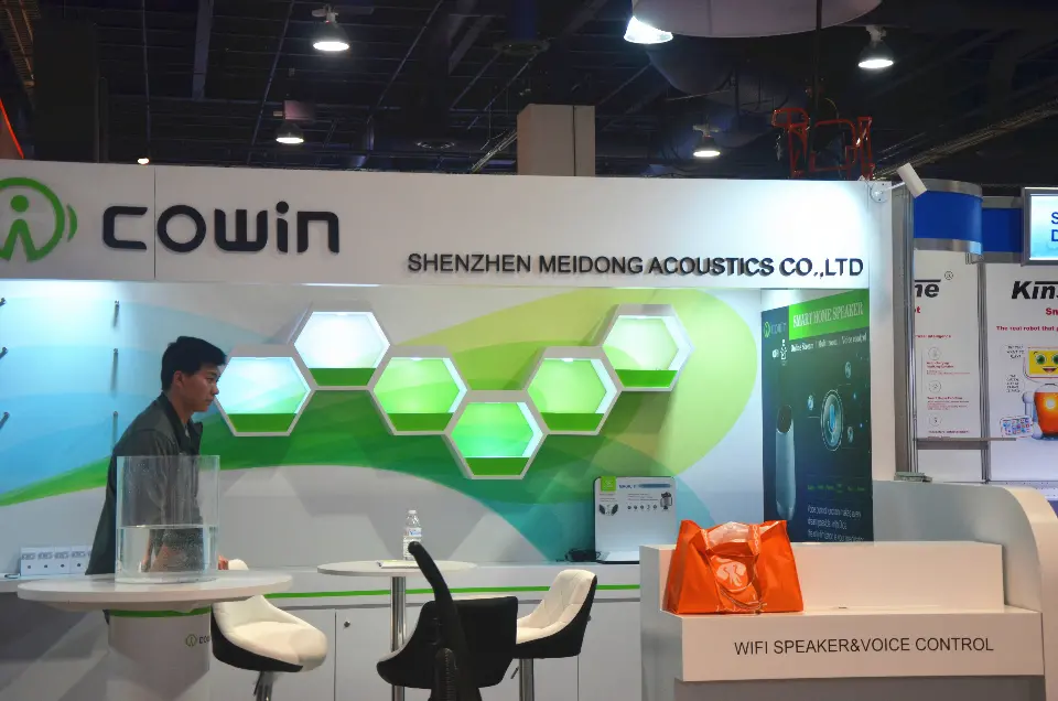 Close view of lit green hexagonal display niches under the Shenzhen Meidong Acoustics name