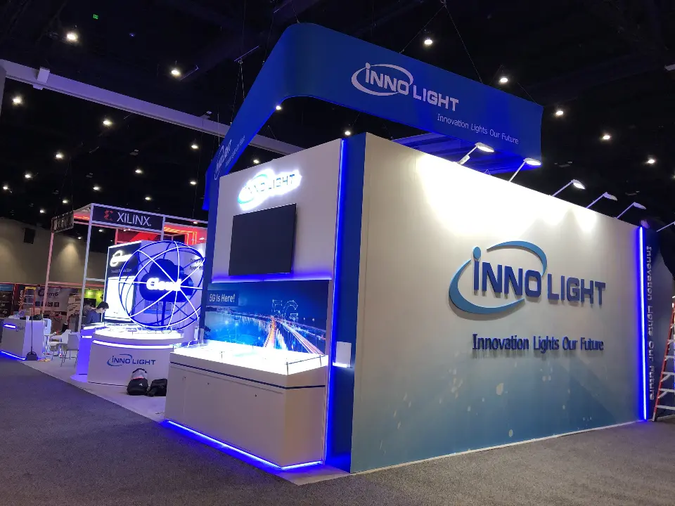 White InnoLight wall with logo and a lit showcase counter