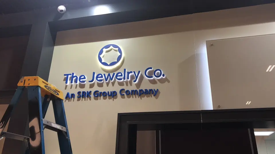 During installation: dimensional blue logo and round emblem on the cream feature wall