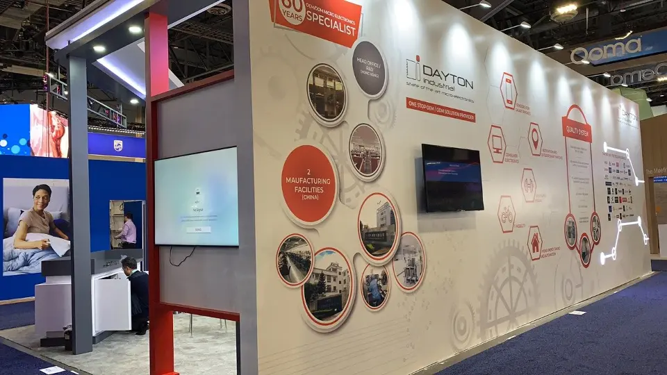 Angled view of the side wall with red circle graphics and a video screen