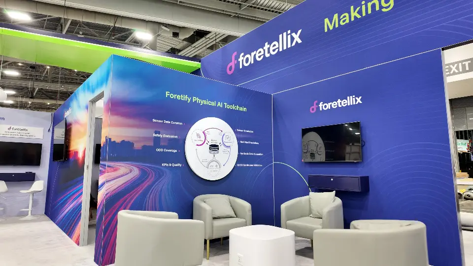 Foretellix lounge corner with white armchairs, wall-mounted screen and Physical AI Toolchain graphic