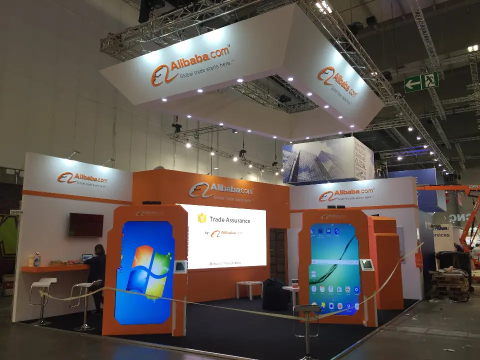 Lit screen frames and white wall counter under the Alibaba.com header